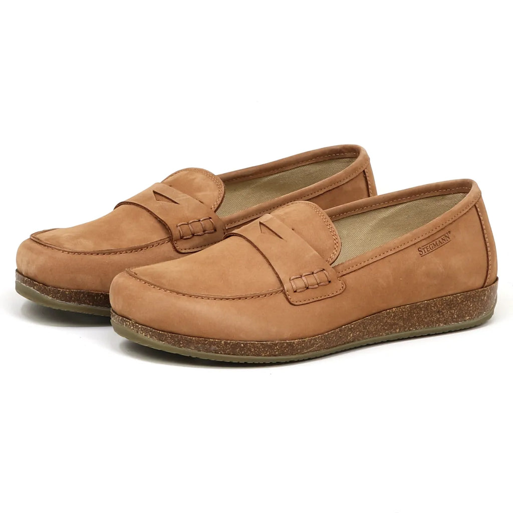 The Women's Victoria Leather Loafer is shown in tan nubuck, with a cushioned insole and textured sole, highlighted by its stitched design; it's viewed from the side at a slight angle.